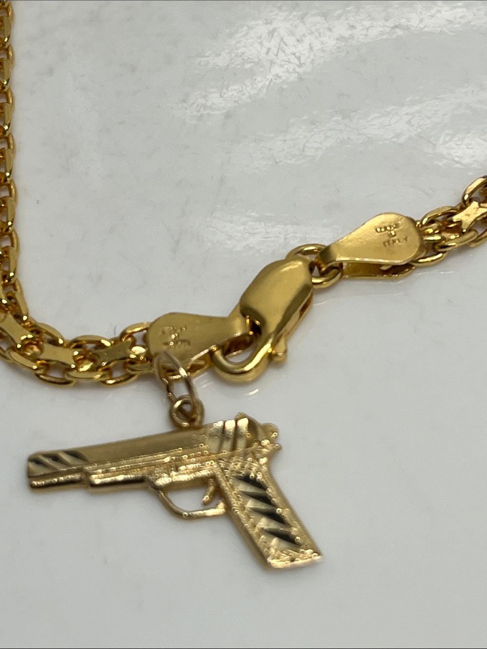 14K rendition of a tactical handgun.  2.8 grams of pure 14K gold.